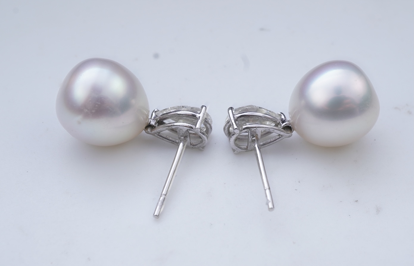 A pair of cultured pearl and diamond earrings